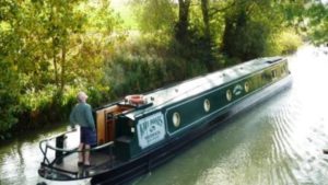 A narrowboat on the canal, a customer on a canal holiday